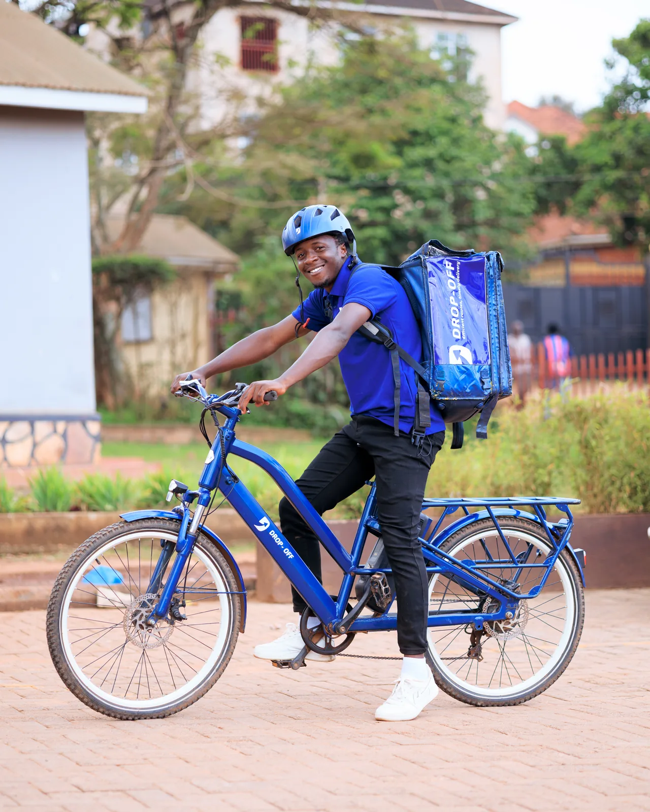 A Drop-Off delivery agent on a branded e-bike, out on a delivery